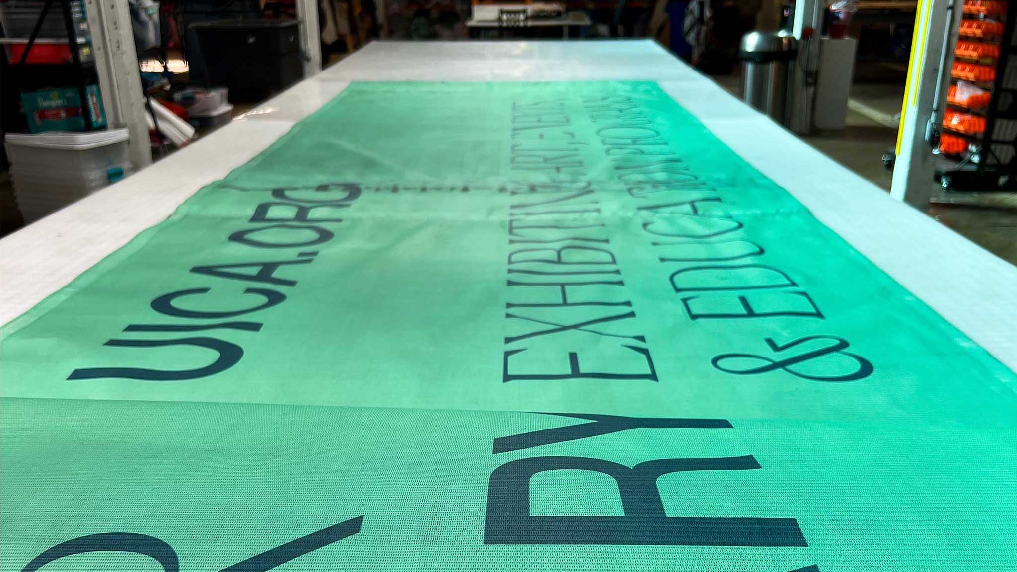 Green banner with printed text on a table in an indoor setting